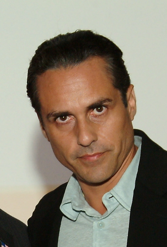 Maurice Benard wearing a light-colored collared shirt and a dark jacket, looking directly at the camera. 
